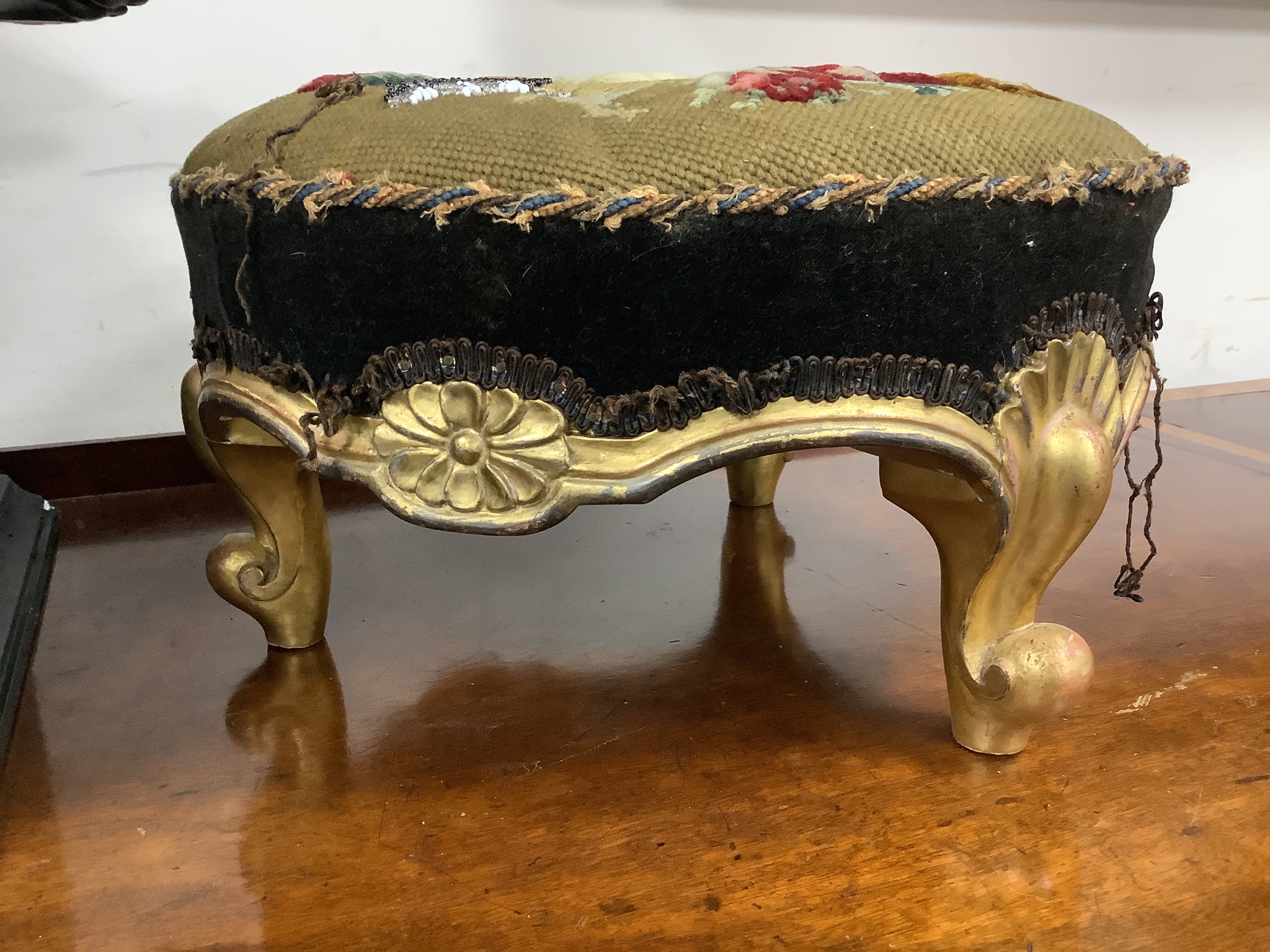 A pair of Victorian floral tapestry circular carved giltwood footstools, length 36cm, height 20cm